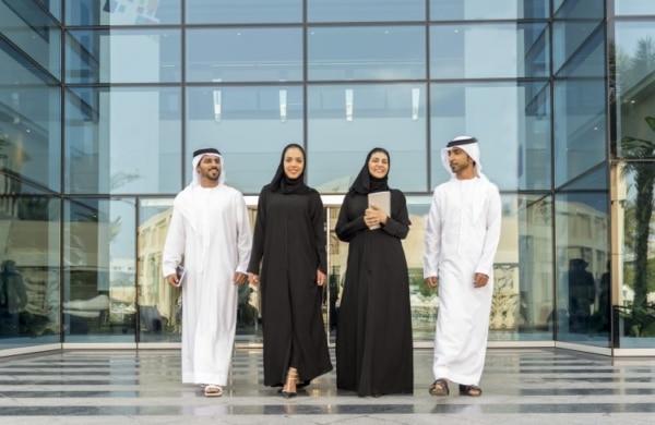 Men in Dubai wear a white tunic and a white turban. Women wear a black dress and a veil.